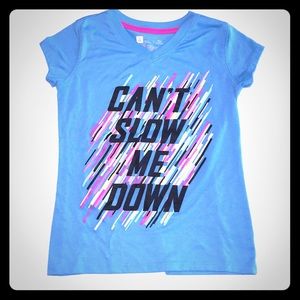 A blue top with letters saying“can’t slow me down”